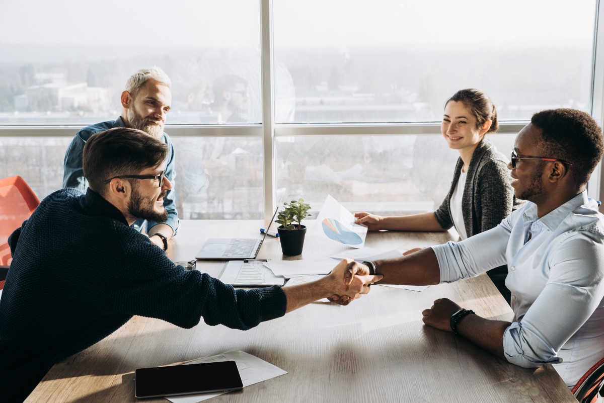 Group shaking hands after agreeing to a deal