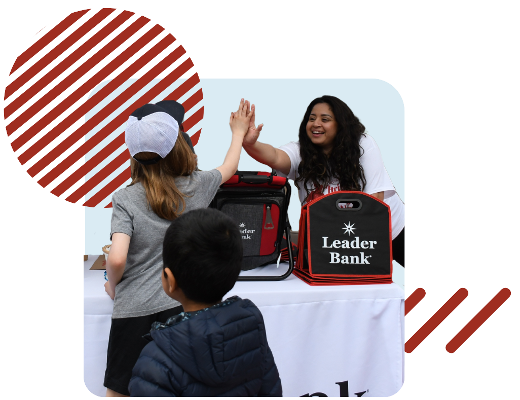 Leader Bank team member high fiving people at an event