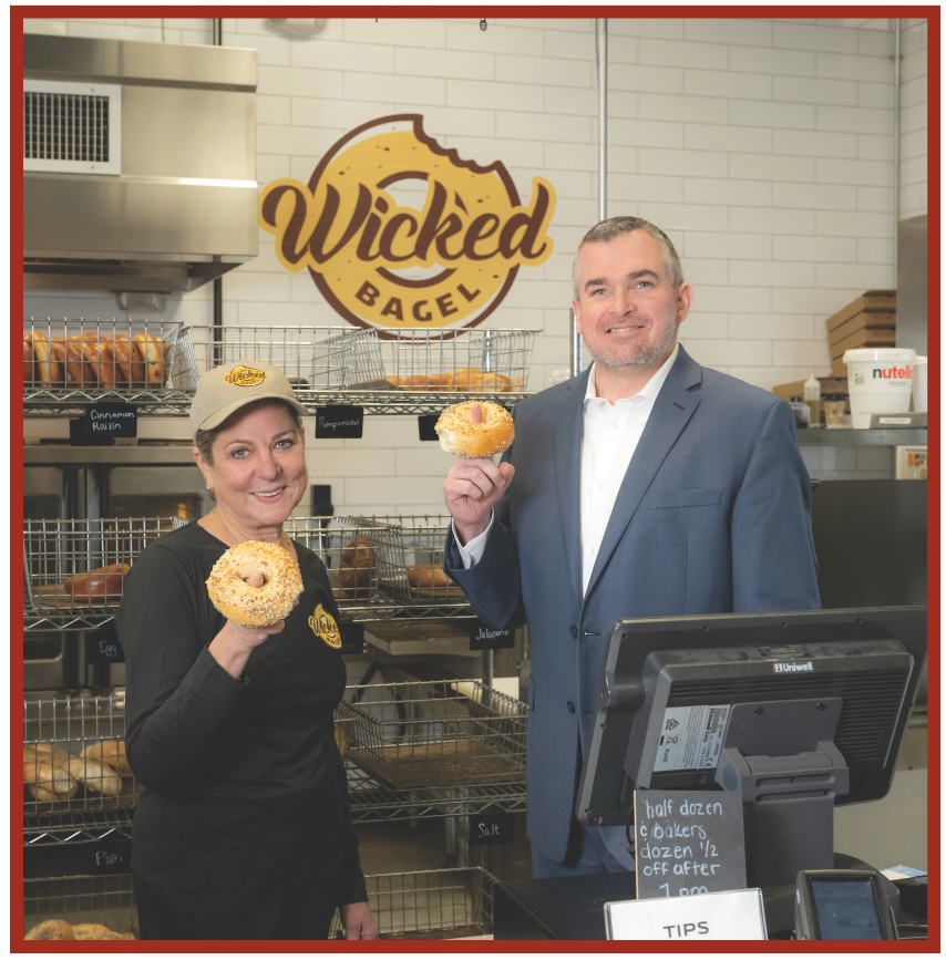 Wicked Bagel Owner Maria Mahoney and Leader Bank Vice President and Commercial Loan Officer Kevin McSweeney pose with some of the businessâs authentic New York style bagels.