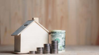 Small wooden house with money in front